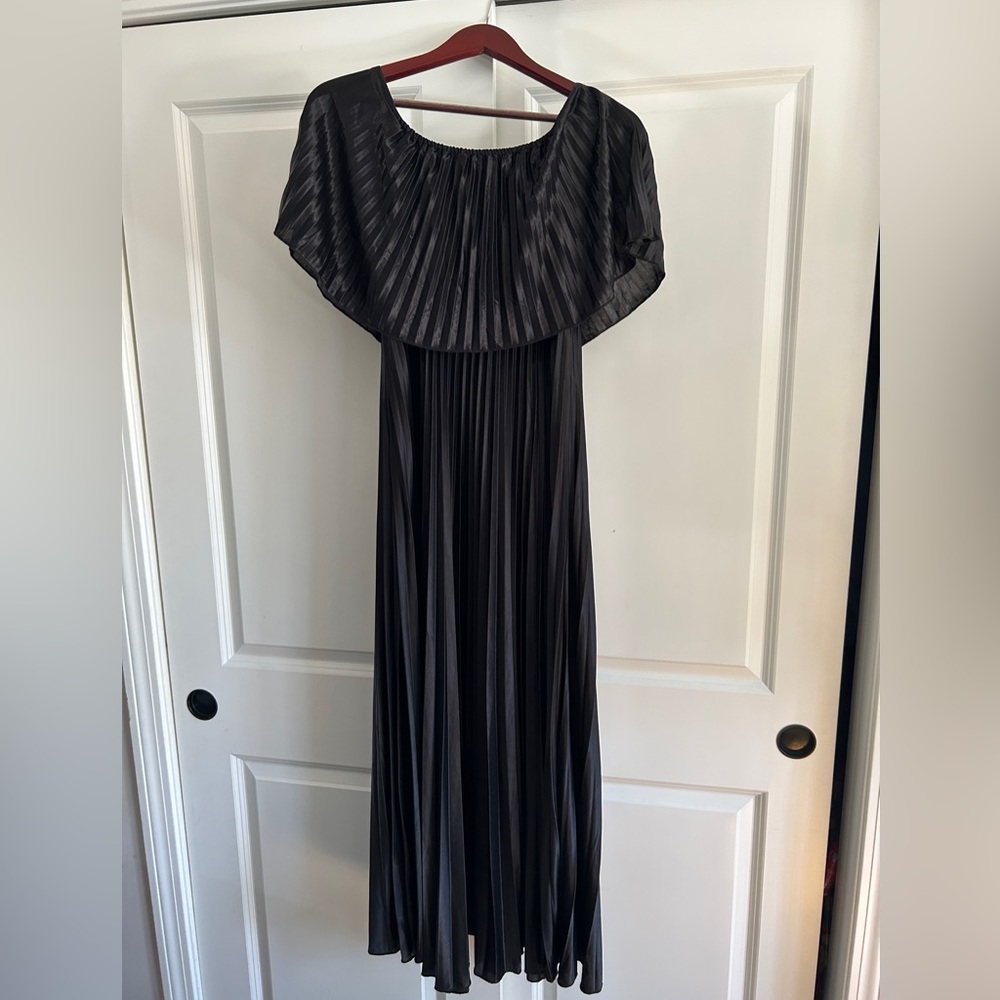 Floor length black off the shoulder dress.